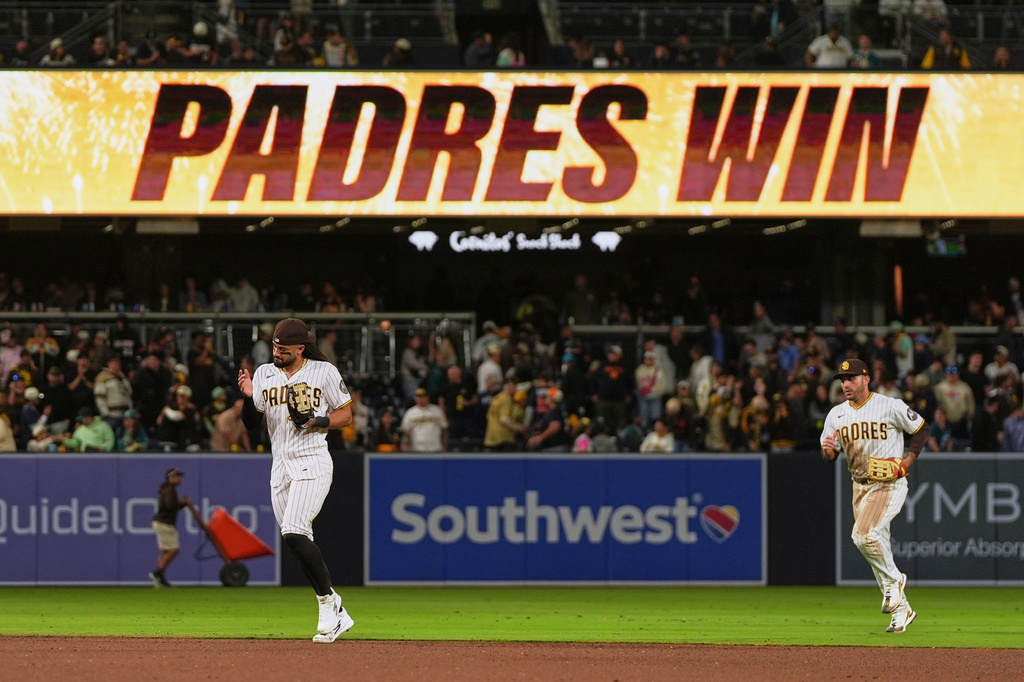 San Diego Padres right fielder Fernando Tatis Jr., left, and left fielder Ramón Laureano celebrate after the Padres defeated the Seattle Mariners 5-2 in a baseball game Thursday, April 16, 2026, in San Diego. (AP Photo/Gregory Bull)
