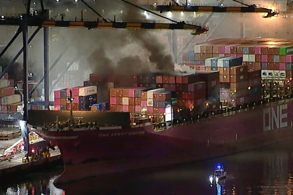 This image taken from video provided by ABC7 shows smoke rising from a blaze on a container ship docked at the Port of Los Angeles, Friday, Nov. 21, 2025, in Los Angeles. (ABC7 via AP)