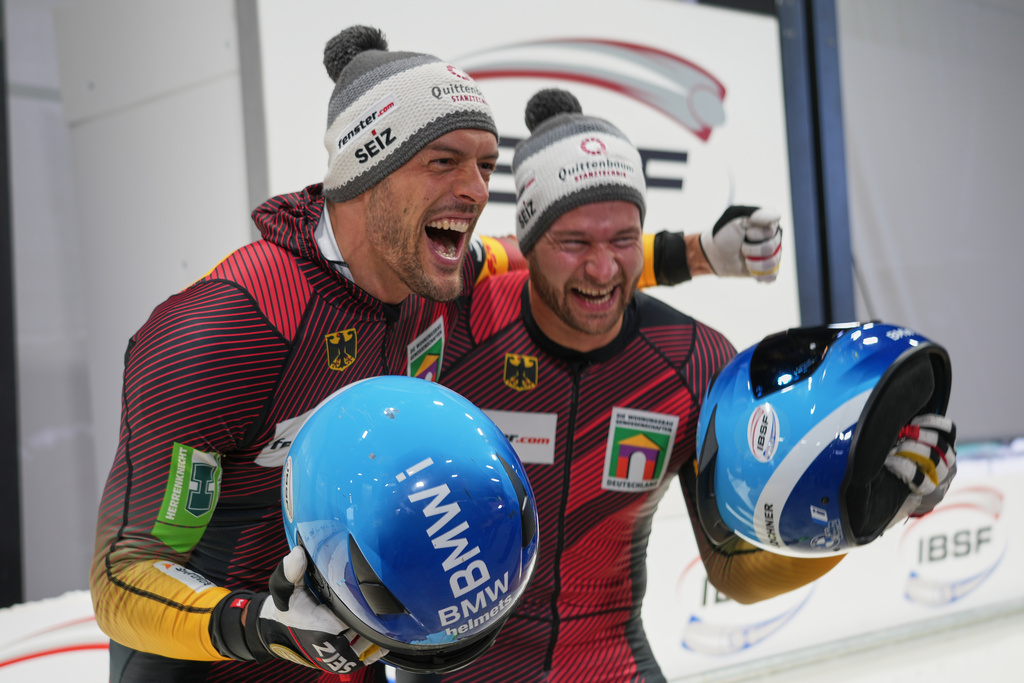 Georg Fleischhauer, left, and Johannes Lochner of Germany celebrate after finishing first in the 2-man bobsleigh World Cup and Olympic test event in Cortina d'Ampezzo, Italy, Saturday, Nov. 22, 2025. (AP Photo/Andrew Medichini)