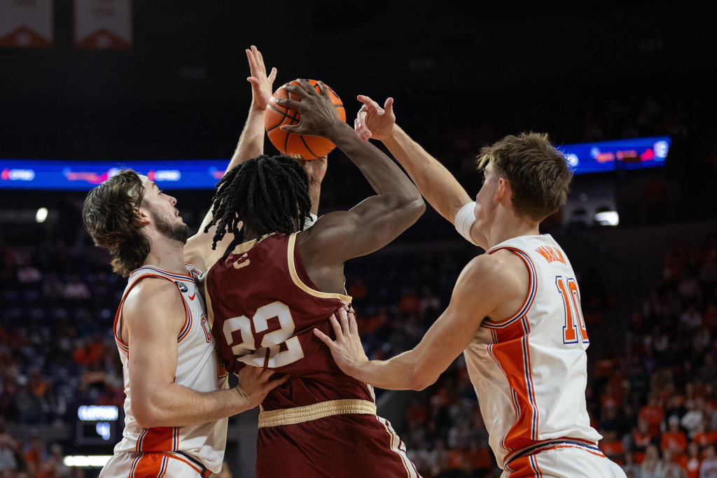 Clemson center Carter Welling (22) and forward Jake Wahlin (10) trap Boston College forward Jayden Hastings (22) during the first half of an NCAA college basketball game Tuesday, Jan. 13, 2026, in Clemson, S.C. (AP Photo/Scott Kinser)