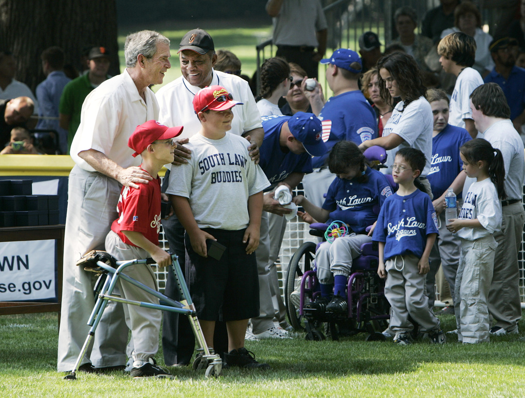 FILE - President George W. Bush, left, and National Baseball Hall of Fame member Willie Mays, back right, pose with Robert Shaffer and Colin Schildt, of Challengers from Thurmont Little League and Civitan Club of Frederick in Thurmont , Md., during a ceremony at the conclusion of the White House Tee Ball Game on the South Lawn, Sunday, July 30, 2006, in Washington. (AP Photo/Manuel Balce Ceneta, File)