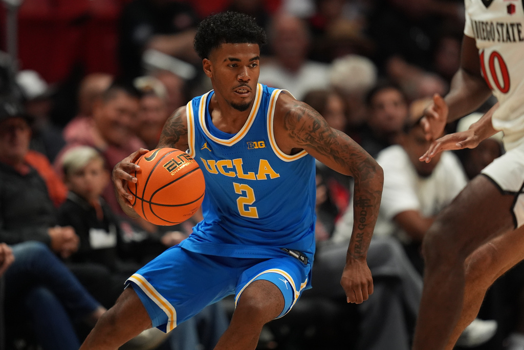 FILE - UCLA guard Donovan Dent (2) dribbles during the second half of an NCAA college basketball exhibition game against San Diego State Friday, Oct. 17, 2025, in San Diego. (AP Photo/Gregory Bull, File)