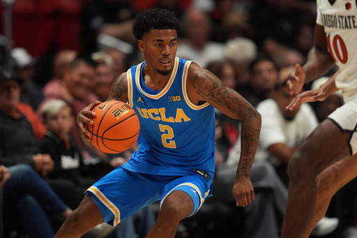 FILE - UCLA guard Donovan Dent (2) dribbles during the second half of an NCAA college basketball exhibition game against San Diego State Friday, Oct. 17, 2025, in San Diego. (AP Photo/Gregory Bull, File) FILE - UCLA guard Donovan Dent (2) dribbles during the second half of an NCAA college basketball exhibition game against San Diego State Friday, Oct. 17, 2025, in San Diego. (AP Photo/Gregory Bull, File)