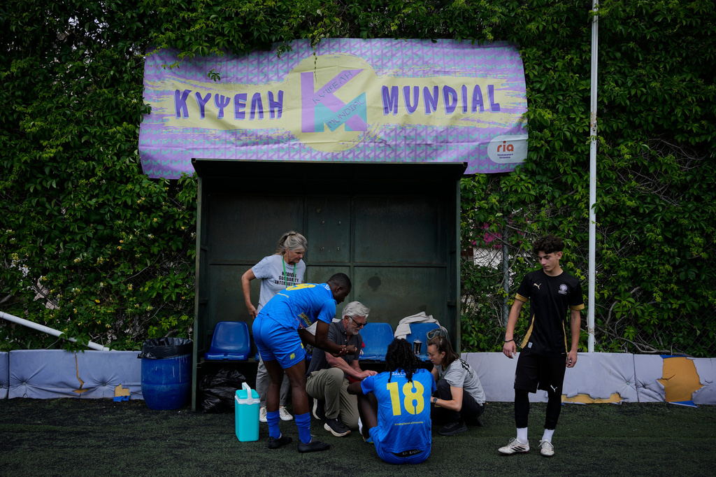 Migrants from Congo prepare before a semifinal soccer match against Mali during the Kypseli Mundial in Athens, Greece, on Sunday, May 24, 2026. (AP Photo/Thanassis Stavrakis)