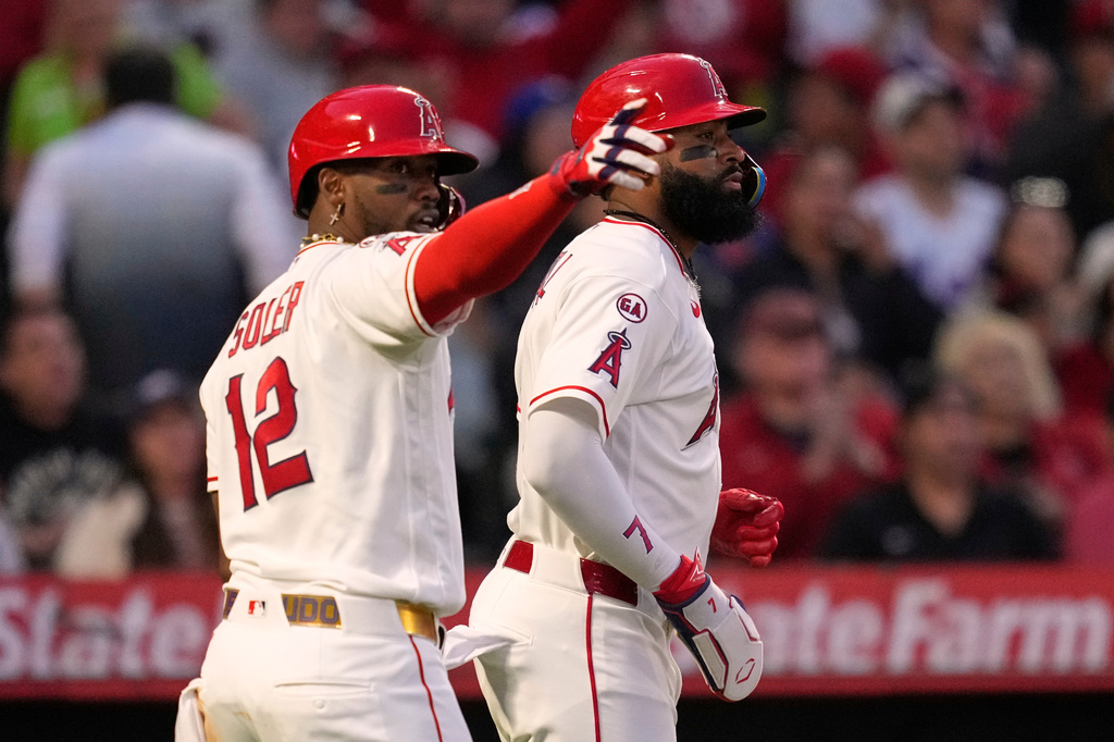 Los Angeles Angels' Jorge Soler, left, gestures toward Vaughn Grissom after Grissom hit an RBI single that scored Soler and Jo Adell, right, during the fourth inning of a baseball game Saturday, May 2, 2026, in Anaheim, Calif. (AP Photo/Mark J. Terrill)