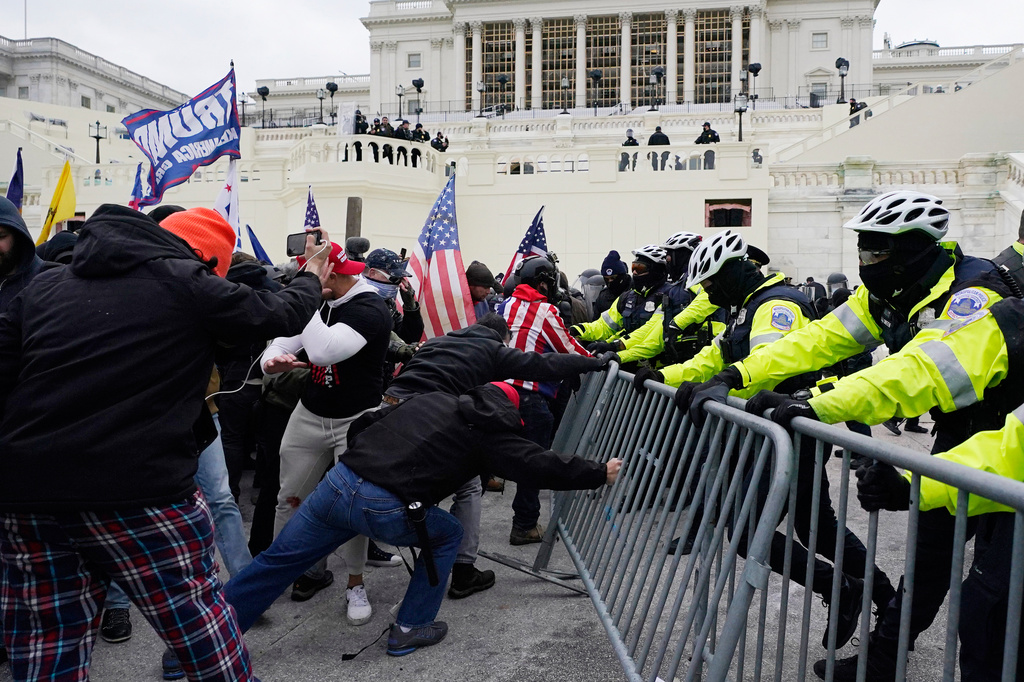 FILE - Supporters of President Donald Trump try to break through a police barrier at the Capitol in Washington, Jan. 6, 2021. (AP Photo/Julio Cortez, File)