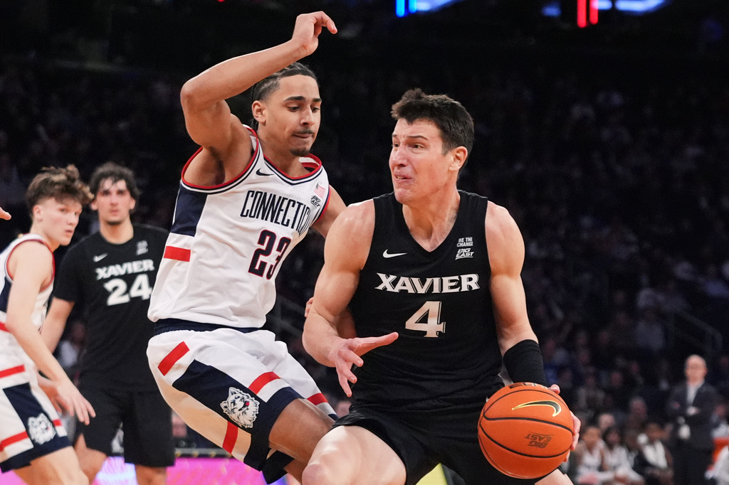 FILE - Xavier's Filip Borovicanin, right, drives on UConn's Jayden Ross (23) during second half of an NCAA college basketball game in the quarterfinals of the Big East basketball tournament Thursday, March 12, 2026, in New York. (AP Photo/Frank Franklin II, File)
