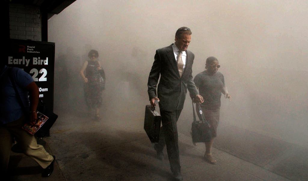 FILE - Pedestrians flee the area of New York's World Trade Center in lower Manhattan on Tuesday, Sept. 11, 2001. (AP Photo/Amy Sancetta, FIle)