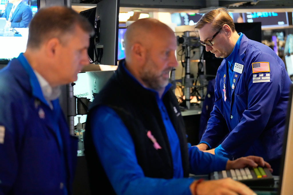 Patrick King, right, and others work on the floor at the New York Stock Exchange in New York, Wednesday, Oct. 1, 2025. (AP Photo/Seth Wenig)