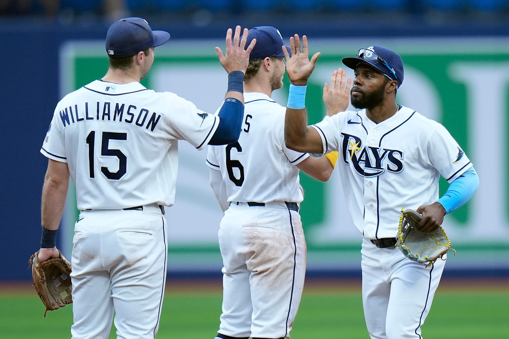Tampa Bay Rays' Cedric Mullins celebrates with Ben Williamson (15) and Taylor Walls (6) after the team defeated the Boston Red Sox during a baseball game Wednesday, June 10, 2026, in St. Petersburg, Fla. (AP Photo/Chris O'Meara)
