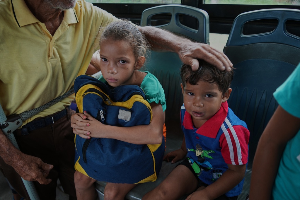 Children are evacuated on a bus before the arrival of Hurricane Melissa in Canizo, a community in Santiago de Cuba, Tuesday, Oct. 28, 2025. (AP Photo/Ramón Espinosa)