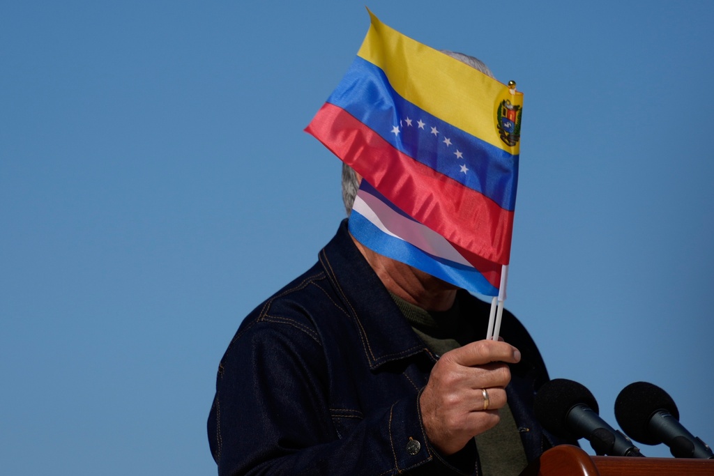 Cuban President Miguel Diaz-Canel waves Venezuelan and Cuban national flags during a rally in Havana, Saturday, Jan. 3, 2026, in solidarity after the U.S. captured President Nicolas Maduro and flew him out of Venezuela. (AP Photo/Ramon Espinosa)