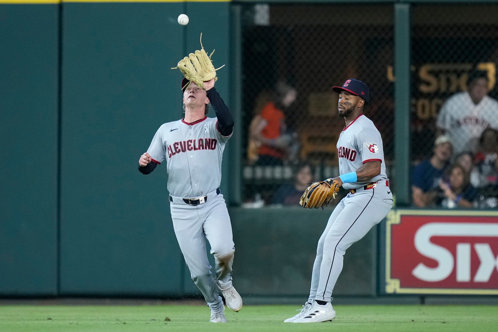 Cleveland Guardians center fielder Petey Halpin, left, and right fielder Kahlil Watson, right, converge on a fly ball during the sixth inning of a baseball game against the Houston Astros, Sunday, June 21, 2026, in Houston. (AP Photo/Kevin M. Cox)