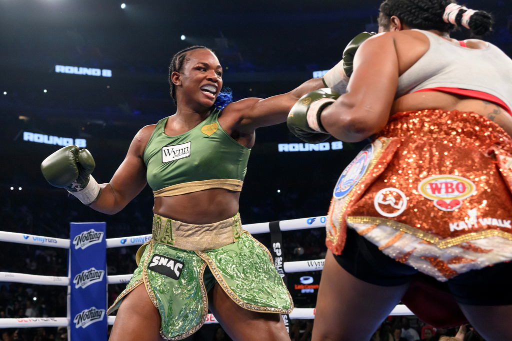 Claressa Shields, left, and Franchon Crews-Dezurn square off in the eighth round of their Undisputed Heavyweight World Championship boxing match, Sunday, Feb. 22, 2026, in Detroit. (AP Photo/Lon Horwedel)