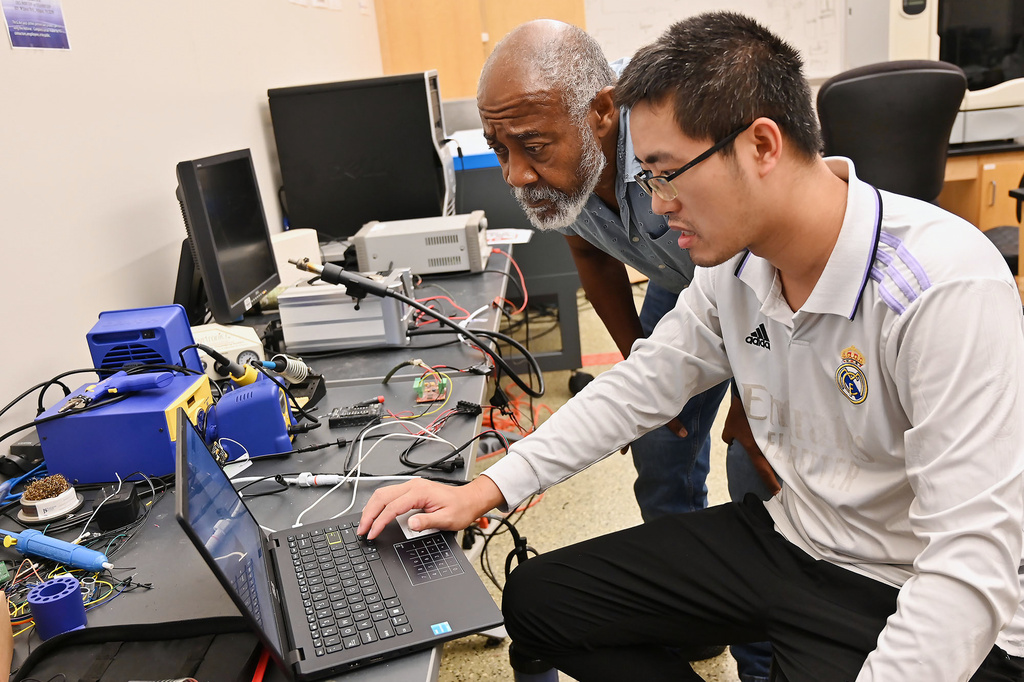 Jackson State Professor of Electrical and Computer Engineering Kamal Ali, left, and Canhao Wang, a computer engineering student, work out a project Thursday, Aug. 6, 2026, in Jackson, Miss. (Vickie D. King/Mississippi Today via AP)