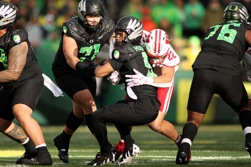 Oregon quarterback Dante Moore (5) is sacked by Wisconsin linebacker Mason Reiger (22) during the first half of an NCAA college football game Saturday, Oct. 25, 2025, in Eugene, Ore. (AP Photo/Lydia Ely) Oregon quarterback Dante Moore (5) is sacked by Wisconsin linebacker Mason Reiger (22) during the first half of an NCAA college football game Saturday, Oct. 25, 2025, in Eugene, Ore. (AP Photo/Lydia Ely)