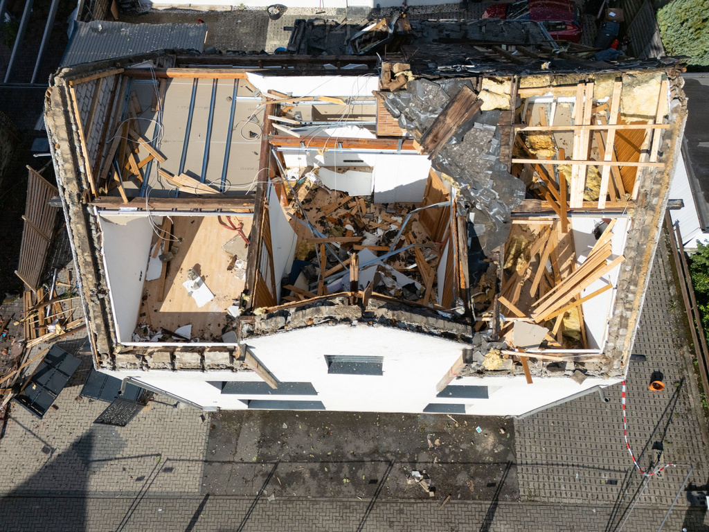Severe damage is visible on several houses in Solms-Oberndorf, Germany, Thursday, Aug. 20, 2026, following a violent thunderstorm. (Boris Roessler/dpa via AP)
