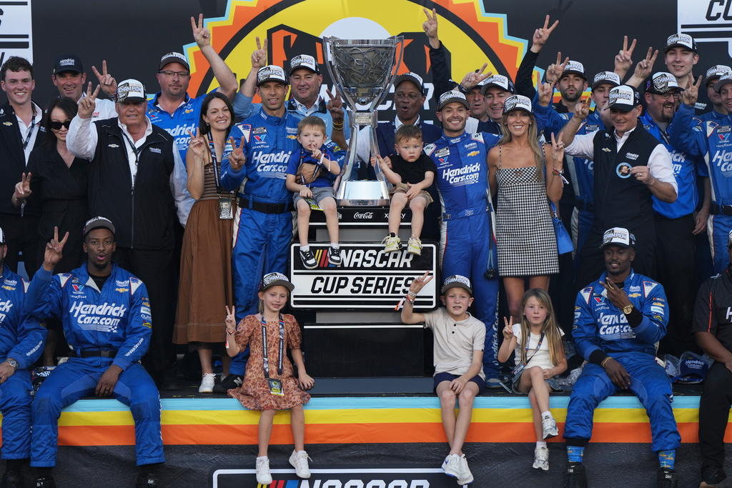 Kyle Larson celebrates with family and teammates after winning the NASCAR Cup Series championship Sunday, Nov. 2, 2025, in Avondale, Ariz. (AP Photo/Rick Scuteri)