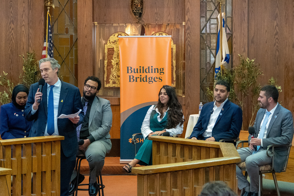 In this photo provided by Sinai Temple, Rabbi Erez Sherman, second left, speaks during an event at the temple in Los Angeles, on Thursday, Sept. 11, 2025, accompanied by panelists from the Middle East, seated from left, Fatema Al Harbi of Bahrain, Haisam Hassanein of Egypt, Maryam Younnes of Israel, Youssef Elazhari of Morocco and Noam Meirov of Israel. (Roy Regev/Sinai Temple via AP)
