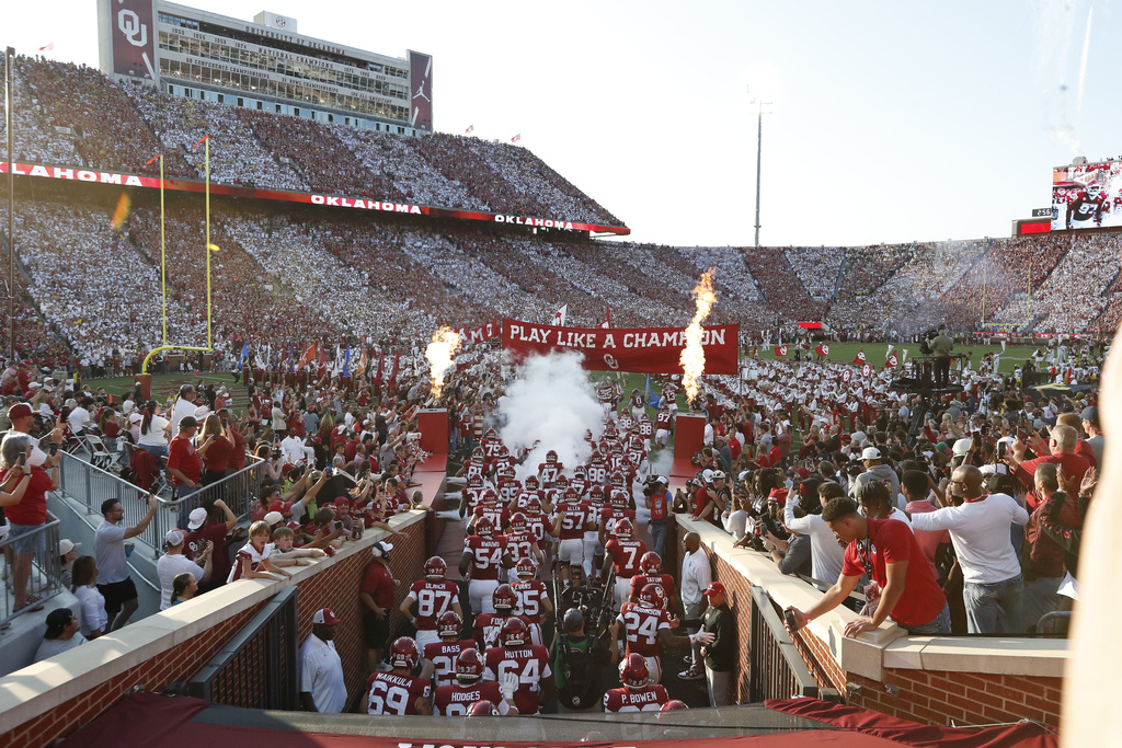 Oklahoma rplayers run onto the field before an NCAA college football game against Michigan, Saturday, Sept. 6, 2025, in Norman, Okla. (AP Photo/Alonzo Adams)