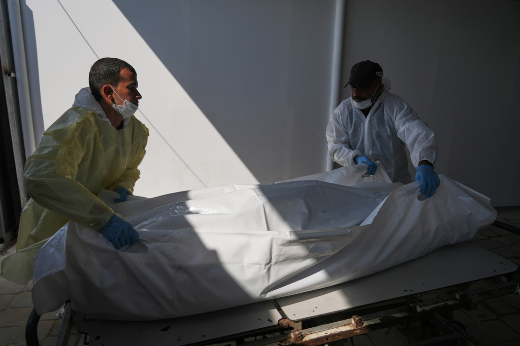 Bodies of unidentified Palestinians returned from Israel as part of the ceasefire deal are brought to Nasser Hospital in Khan Younis, Gaza Strip, Wednesday Nov. 5, 2025. (AP Photo/Jehad Alshrafi)