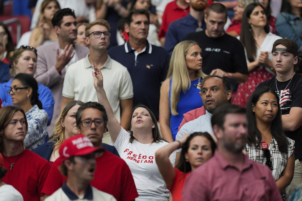 Attendees react during a memorial for conservative activist Charlie Kirk, Sunday, Sept. 21, 2025, at State Farm Stadium in Glendale, Ariz. (AP Photo/Julia Demaree Nikhinson)