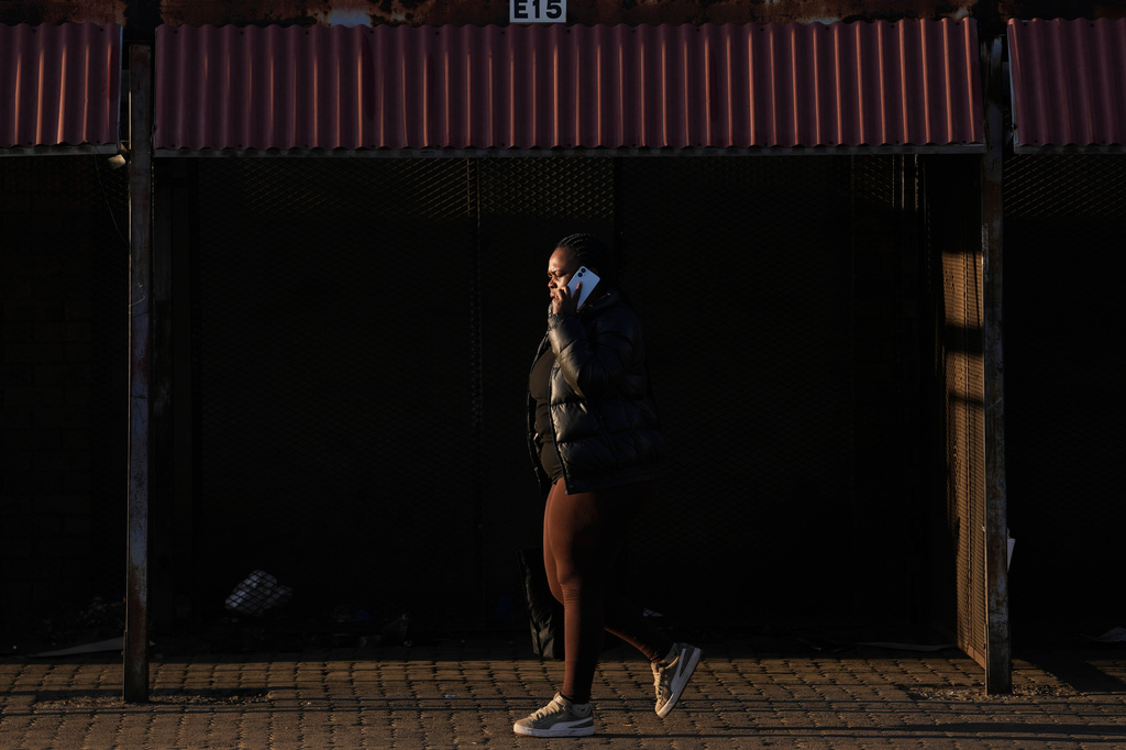 A woman walks past empty market stalls in Thokoza township, east of Johannesburg, South Africa, Tuesday, June 30, 2026. (AP Photo/Themba Hadebe)