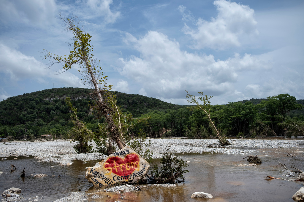 A boulder with artwork honoring Hill Country lays on the Guadalupe River after heavy floods on Friday, July 17, 2026, in Ingram, Texas. (AP Photo/Joel Angel Juarez)