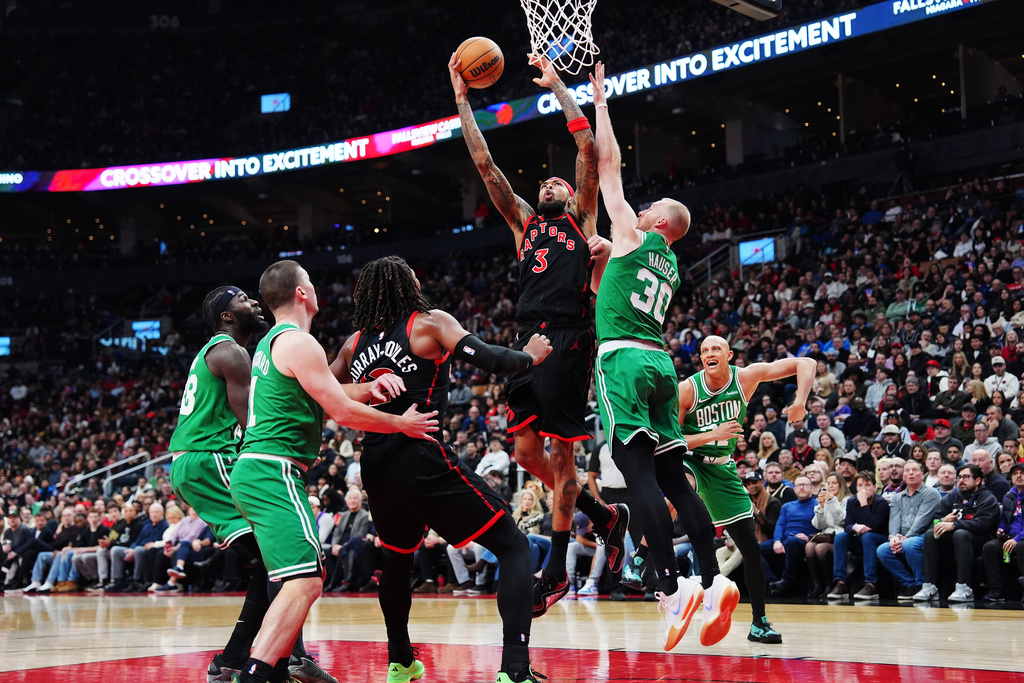 Toronto Raptors' Brandon Ingram (3) goes up to shoot over Boston Celtics' Sam Hauser (30) during first-half NBA basketball game action in Toronto, Saturday, Dec. 20, 2025. (Frank Gunn/The Canadian Press via AP)