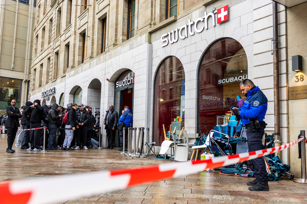 Swiss police officers secure the area where customers queue to buy the new Royal Pop watch by Swatch and Audemars Piguet, in Geneva, Switzerland, Saturday, May 16, 2026. (Salvatore Di Nolfi/Keystone via AP)