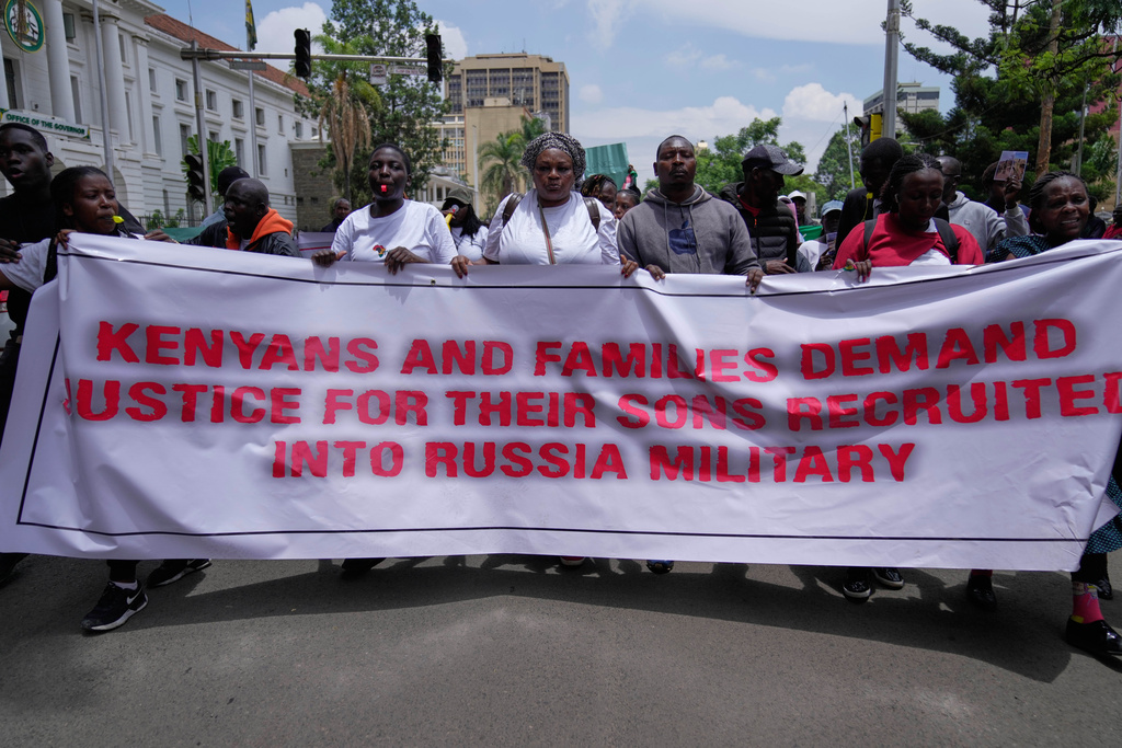 Family members of Kenyans who joined the Russian army in Ukraine hold placards and photos of their loved ones during a protest calling for their repatriation in Nairobi, Kenya, Thursday, March 5, 2026. (AP Photo/Brian Inganga)