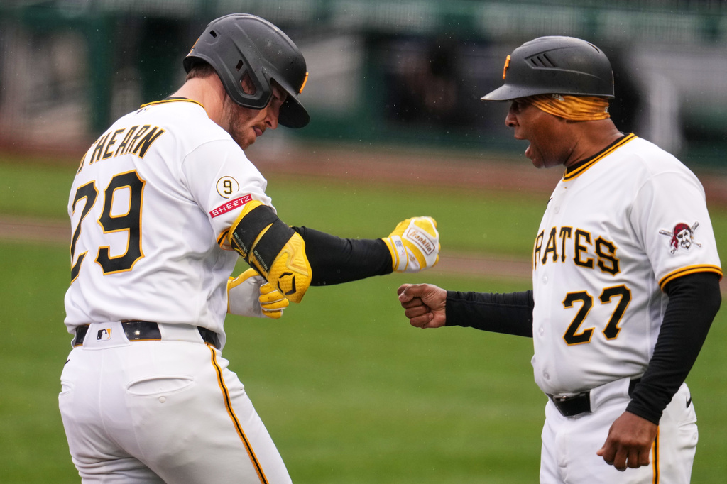 Pittsburgh Pirates' Ryan O'Hearn (29) is greeted by third base coach Tony Beasley (27) as he rounds third base after hitting a two-run home run off Colorado Rockies pitcher Chase Dollander during the first inning of a baseball game in Pittsburgh, Thursday, May 14, 2026. (AP Photo/Gene J. Puskar)