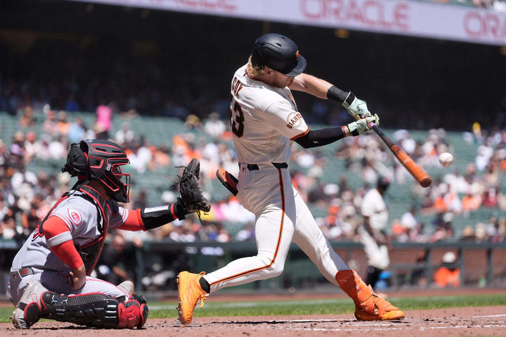 San Francisco Giants' Jonah Cox, right, hits a two-run home run next to Cincinnati Reds catcher Jose Trevino during the second inning of a baseball game, Wednesday, Aug. 26, 2026, in San Francisco. (AP Photo/Jeff Chiu)