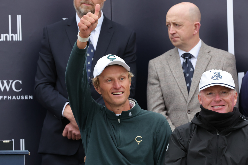 Adrian Meronk of Poland celebrates his victory with caddie Stuart Beck, right, at the Old Course at St Andrews, Scotland, Sunday Oct. 4, 2026. (Steve Welsh/PA via AP)