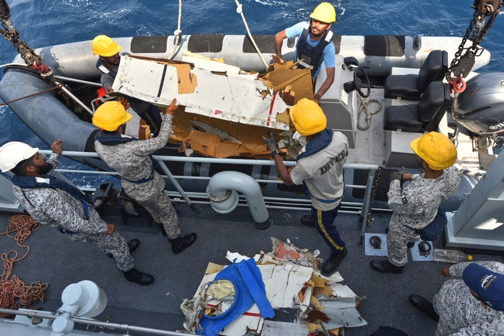 In this photo released by Pakistan Navy, Pakistan Navy personnel shift the wreckage of a cargo plane of the private carrier K2 Airways into a naval ship after recovering them from deep sea near Omara, a town some 360 kms. (220 miles) west of Karachi, Pakistan, Wednesday, July 8, 2026. (Pakistan Navy via AP)