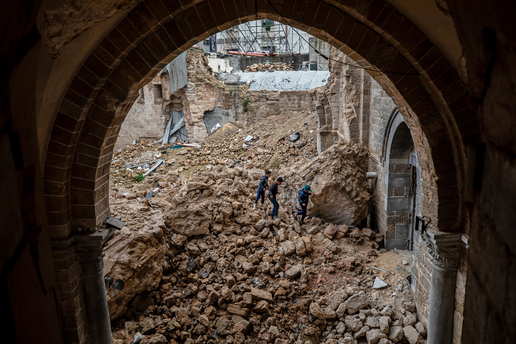 Palestinian children walk through rubble at the Great Omari Mosque in Gaza City after it was damaged by an Israeli strike during the war with Hamas, Wednesday. Feb. 12, 2025. (AP Photo/Jehad Alshrafi)