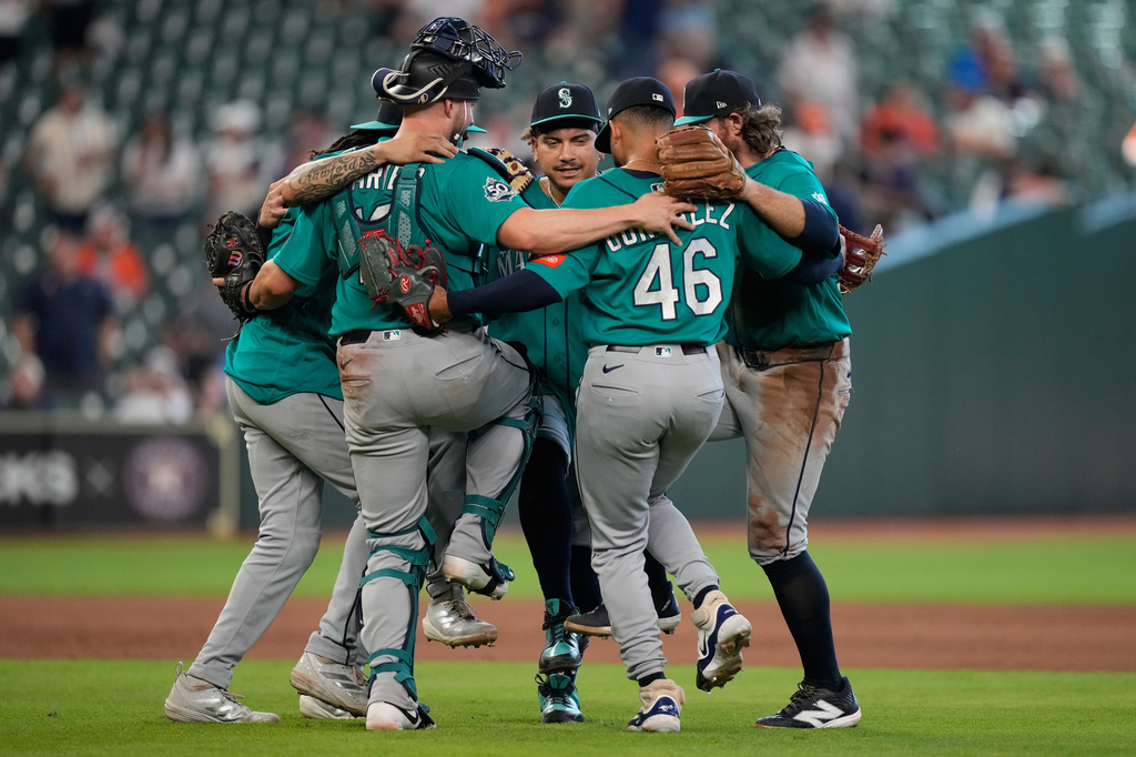 Seattle Mariners players celebrate after winning a baseball game against the Houston Astros in Houston, Thursday, May 14, 2026. (AP Photo/Ashley Landis)