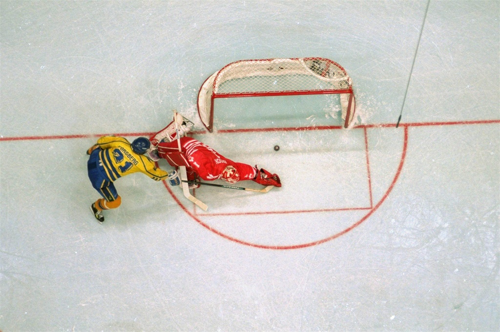 FILE - Sweden's Peter Forsberg flips the puck past Canadian goalkeeper Corey Hirsch, scoring the game winning shootout goal in their gold medal game of the Olympics in Lillehammer, February 27, 1994. (AP Photo/Al Behrman, File)