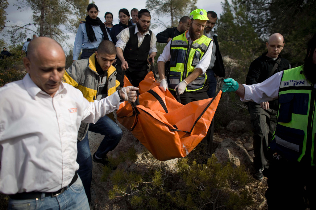 FILE - Israeli rescue workers carry the body of U.S. tourist Kristine Luken after she was found in a wooded area near the village of Mata, outside Jerusalem, Sunday, Dec. 19, 2010. (AP Photo/Tara Todras-Whitehill, File)