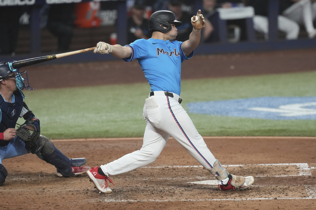 Miami Marlins' Jakob Marsee hits a triple to center field during the third inning of a baseball game against the Toronto Blue Jays, Sunday, Aug. 24, 2025, in Miami. (AP Photo/Marta Lavandier)