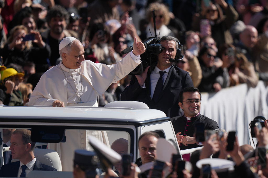 Pope Leo XIV gives his thumbs up as he arrives for his weekly general audience in St. Peter's Square, at the Vatican, Wednesday, March 18, 2026. (AP Photo/Andrew Medichini)