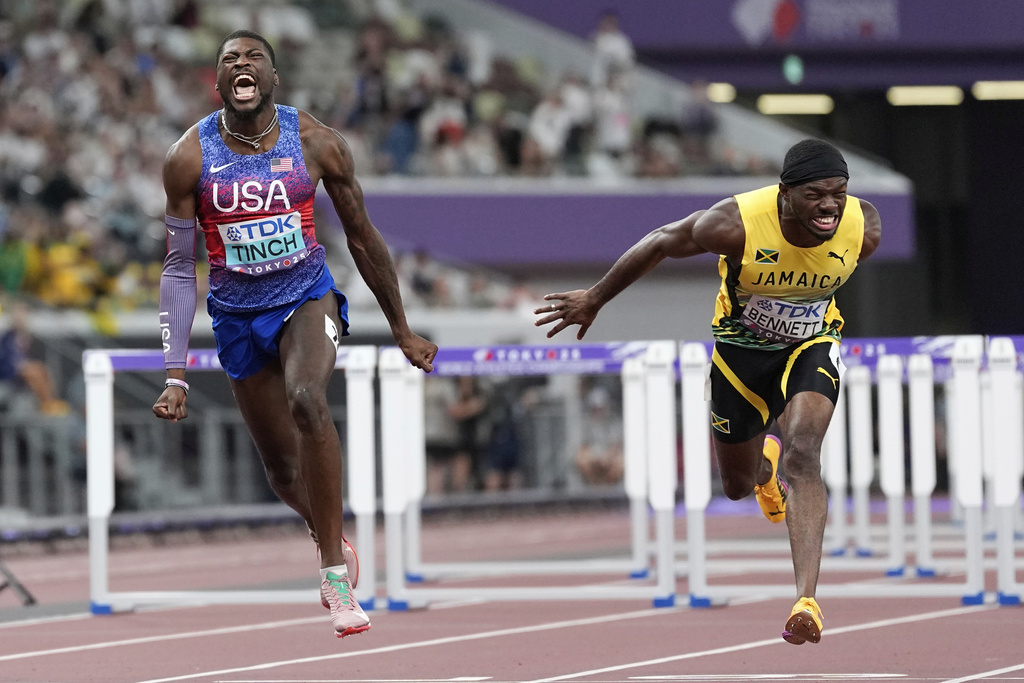 United States' Cordell Tinch wins the gold ahead of Jamaica's Orlando Bennett, silver, in the men's 110 meters hurdles final at the World Athletics Championships in Tokyo, Tuesday, Sept. 16, 2025. (AP Photo/Petr David Josek)