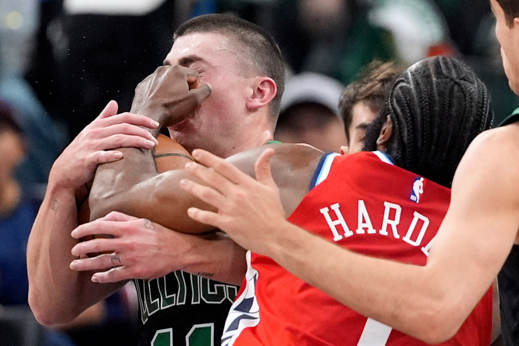 Boston Celtics guard Payton Pritchard, left, is hit in the face by Los Angeles Clippers guard James Harden as Harden drives toward the basket during the first half of an NBA basketball game Saturday, Jan. 3, 2026, in Inglewood, Calif. (AP Photo/Mark J. Terrill)