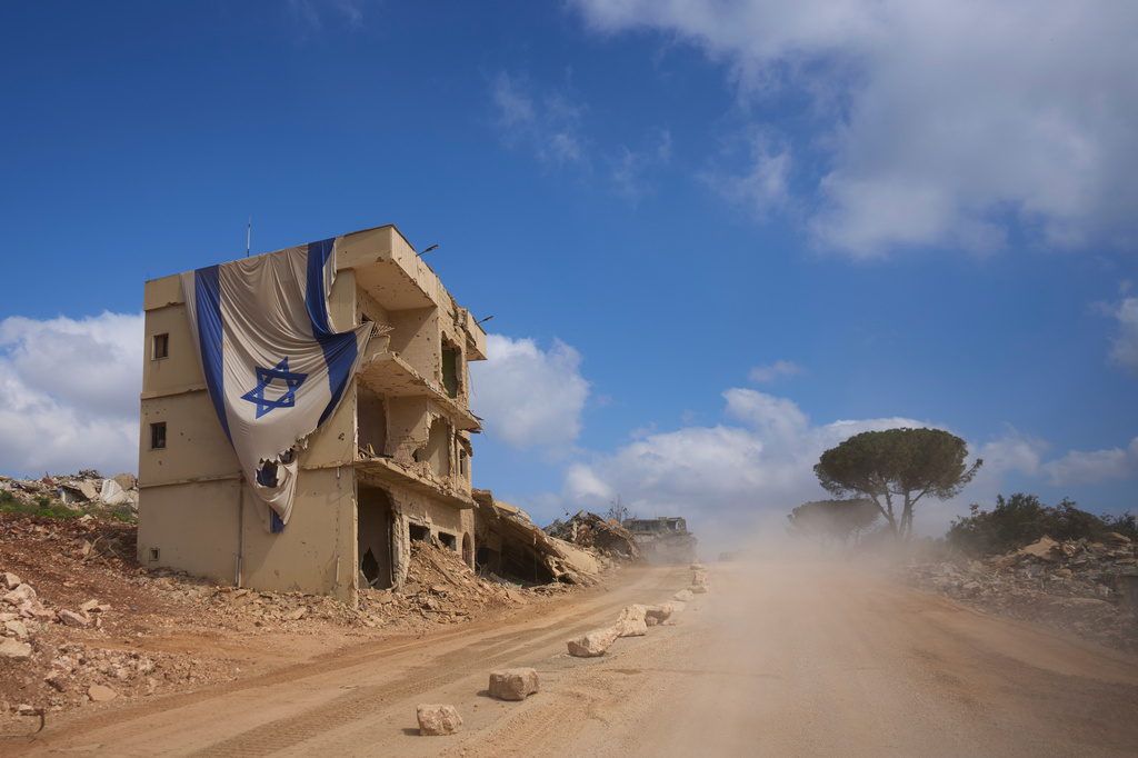 An Israeli flag hangs from a building in an area occupied by Israeli troops in southern Lebanon, Thursday, July 9, 2026. The Israeli military invited reporters on a tour of the strategic mountain topped by the Crusader-built Beaufort Castle months after launching a ground invasion that captured dozens of Lebanese villages and towns in southern Lebanon. (AP Photo/Ohad Zwigenberg)
