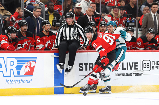 New Jersey Devils' Dawson Mercer (91) and San Jose Sharks' Philipp Kurashev, right, compete for the puck during the first period of an NHL hockey game Friday, Oct. 24, 2025, in Newark, N.J. (AP Photo/Pamela Smith) New Jersey Devils' Dawson Mercer (91) and San Jose Sharks' Philipp Kurashev, right, compete for the puck during the first period of an NHL hockey game Friday, Oct. 24, 2025, in Newark, N.J. (AP Photo/Pamela Smith)