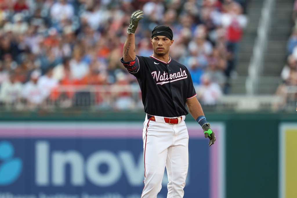 Washington Nationals' Daylen Lile gestures towards his team's dugout after hitting a double against Baltimore Orioles pitcher Shane Baz during the second inning of a baseball game, Friday, May 15, 2026, in Washington. (AP Photo/Terrance Williams)