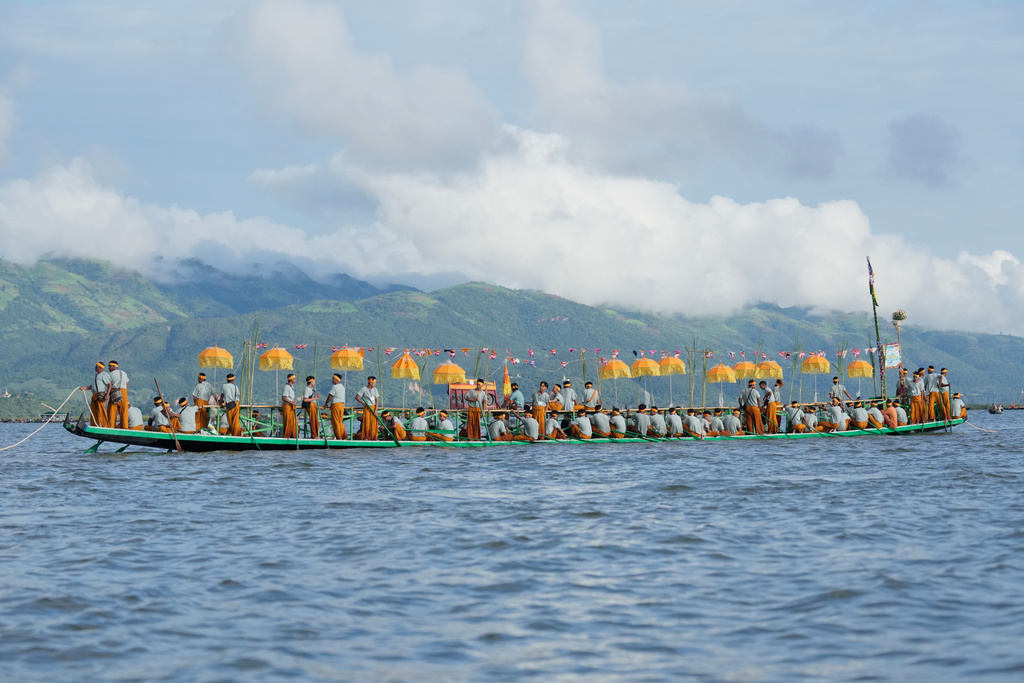 Intha ethnic people wait on a long boat in a procession carrying Buddha images to a monastery during the Phaung Daw Oo pagoda festival Friday, Sept. 26, 2025, in Inle Lake, southern Shan State, Myanmar. (AP Photo/Thein Zaw)
