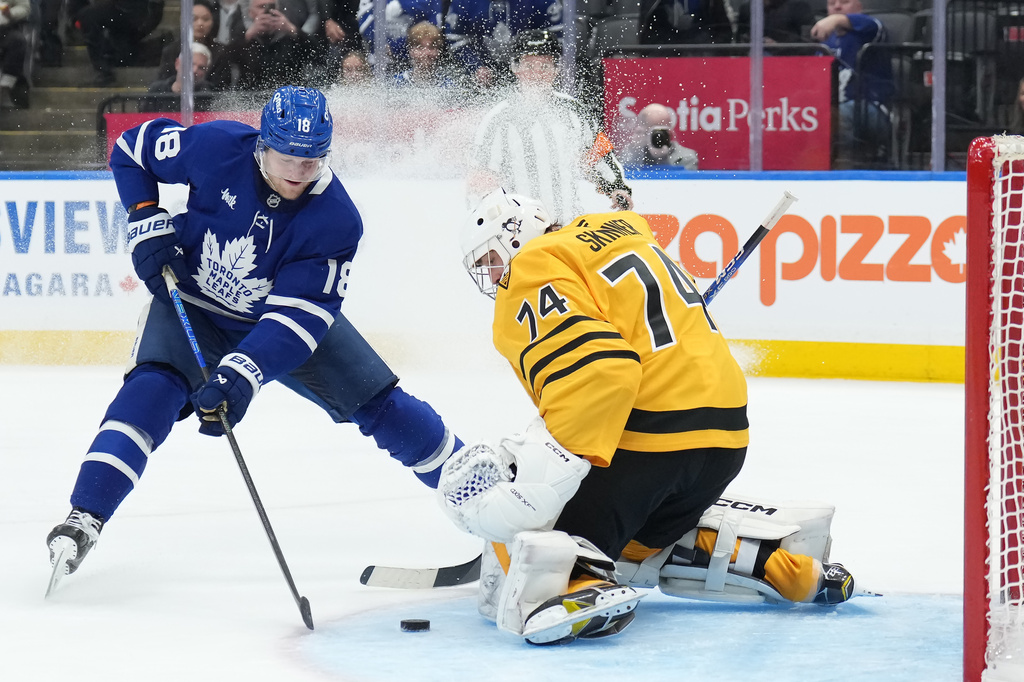 Toronto Maple Leafs forward Steven Lorentz (18) scores past Pittsburgh Penguins goaltender Stuart Skinner (74) during the second period of an NHL hockey game in Toronto, Tuesday, Dec. 23, 2025. (Nathan Denette/The Canadian Press via AP)