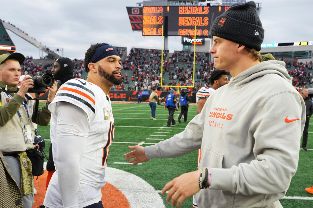 Cincinnati Bengals quarterback Joe Burrow (9), right, greets Chicago Bears quarterback Caleb Williams (18) after an NFL football game, Sunday, Nov. 2, 2025, in Cincinnati. (AP Photo/Jeff Dean)