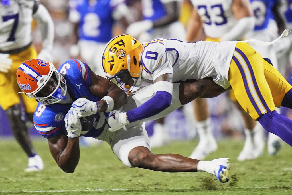 Florida wide receiver J. Michael Sturdivant (9) pulls in a pass against LSU safety Tamarcus Cooley (0) in the second half of an NCAA college football game, Saturday, Sept. 13, 2025, in Baton Rouge, La. (AP Photo/Gerald Herbert)